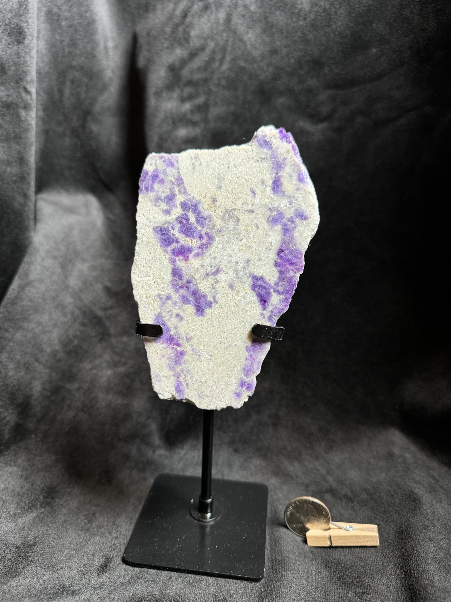 Hackmanite Slab on a metal stand